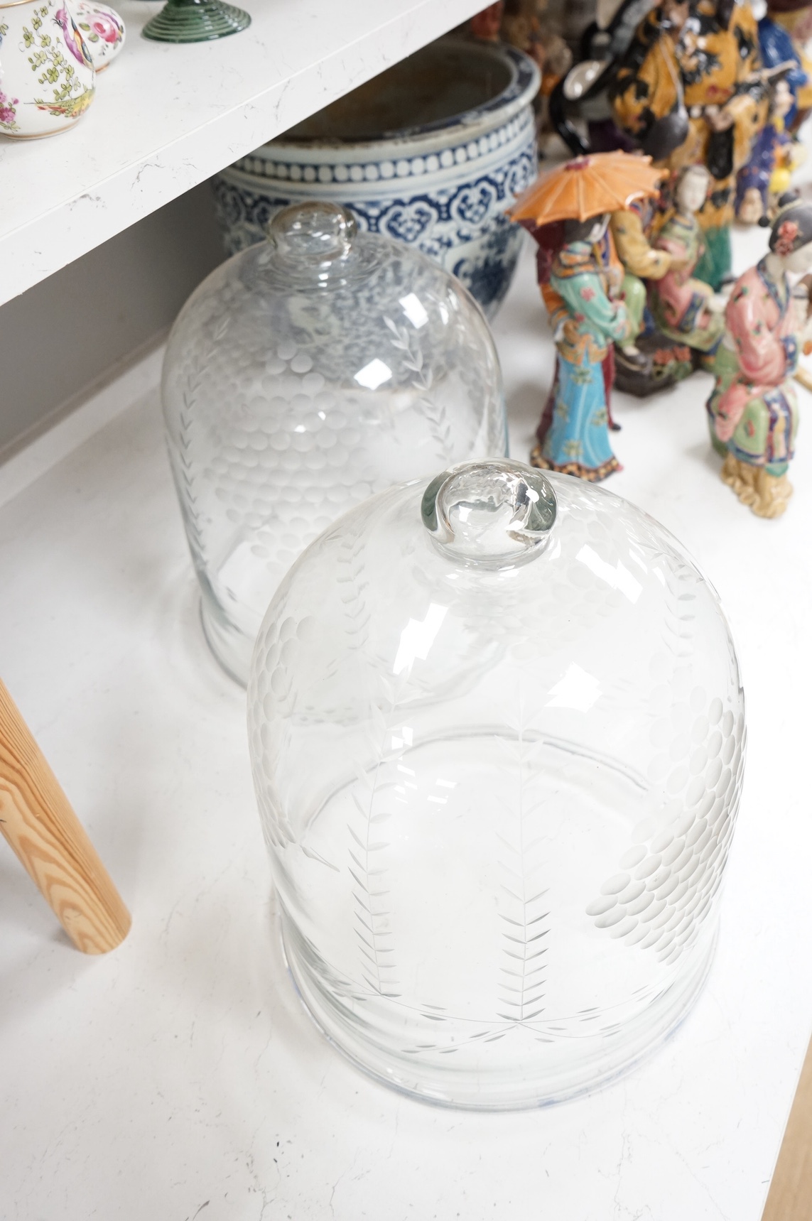 A pair of continental glass engraved cheese domes, 37cm high. Condition - good